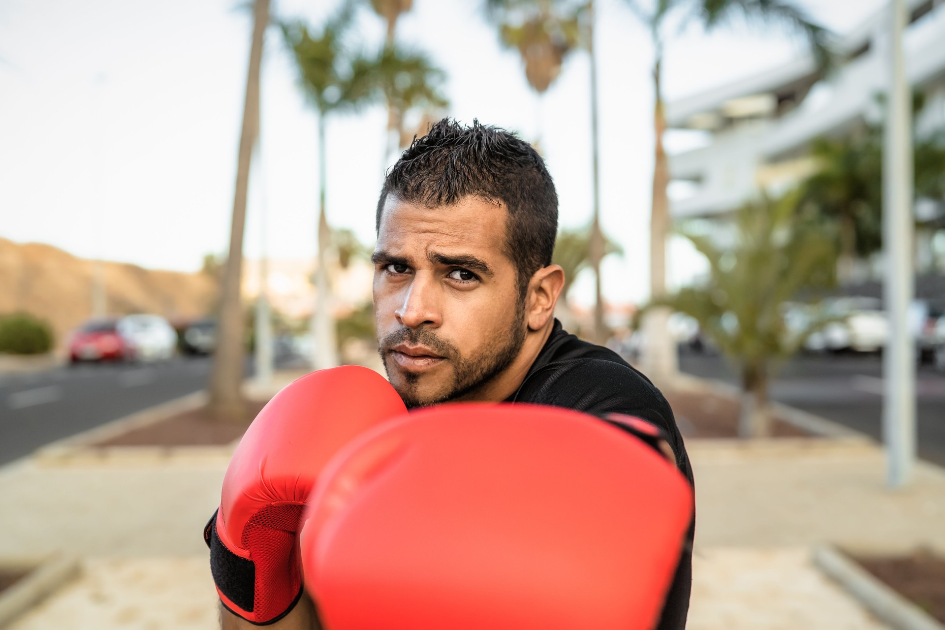 Young Latin man doing boxing exercises session outdoor - Health fitness and workout concept